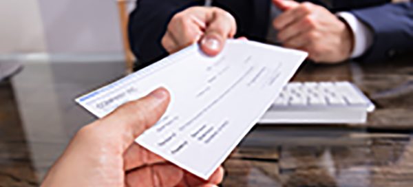 person handing over a check to someone