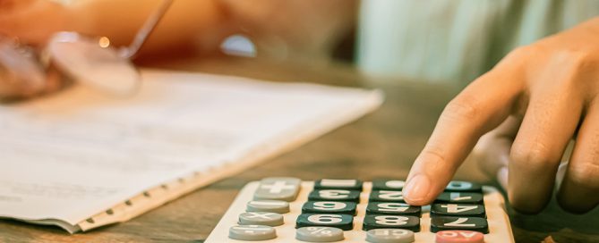 hand using calculator Calculating bonus