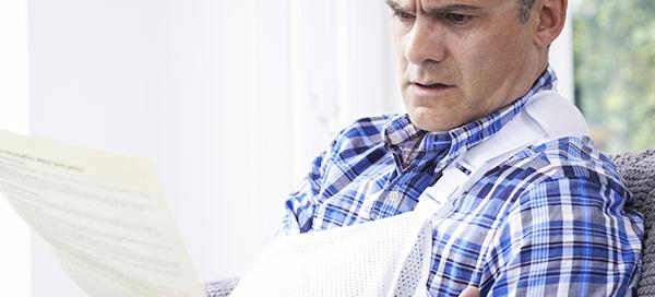 man_injured_reading_letter