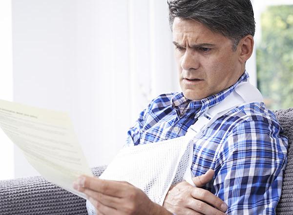 man_injured_reading_letter